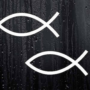 May include: Two white ichthys symbols, also known as the Jesus fish, are displayed on a black background with water droplets.