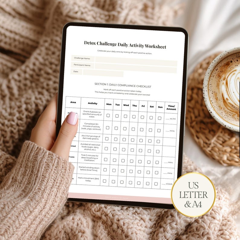 May include: A digital tablet displays a "Detox Challenge Daily Activity Worksheet" with checkboxes for tracking daily habits. The worksheet includes sections for activity, and time/amount. A cup of coffee sits to the right. The tablet is held by a person.