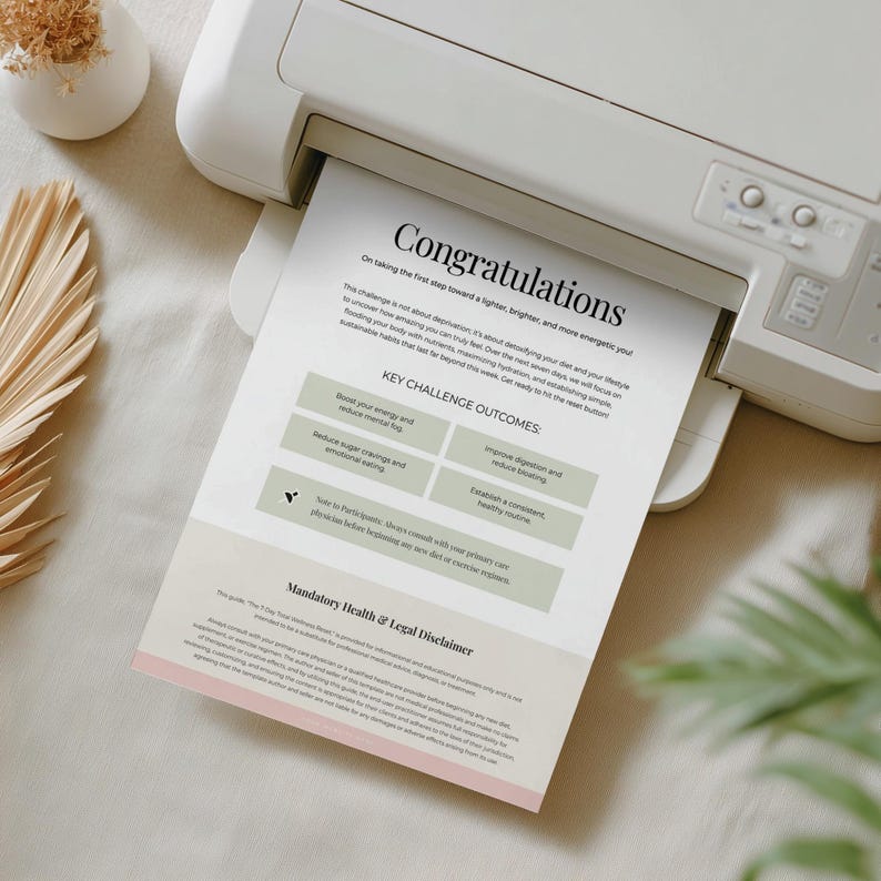 May include: A white printer printing a document with the word "Congratulations" at the top. The document lists key challenge outcomes, including boosting energy, reducing sugar cravings, improving digestion, and establishing a healthy routine. A small vase with dried flowers is in the background.