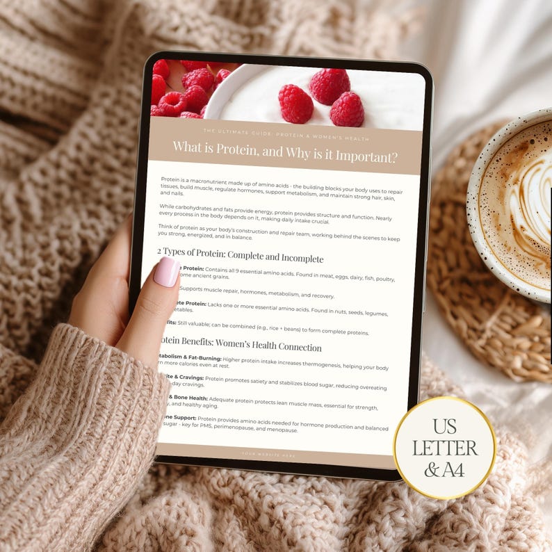 May include: A digital tablet displays a health and wellness guide titled "What is Protein, and Why is it Important?" The image includes text about protein types and benefits. A cup of coffee and raspberries are in the background.