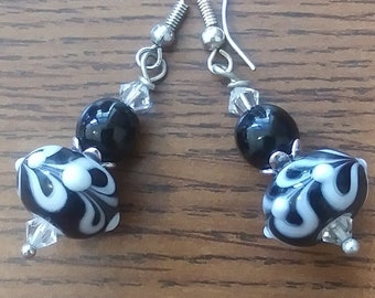 May include: Black and white swirl glass bead earrings with silver hooks and crystal accents.