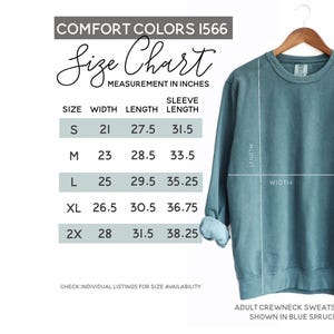 May include: Size chart for a crewneck sweatshirt in Comfort Colors 1566. The chart shows measurements in inches for width, length, and sleeve length for sizes S, M, L, XL, and 2X.