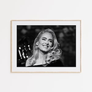 May include: A set of three ceramic mugs with a speckled, cream-colored glaze. Each mug features a different hand-painted design: a blue and green leaf, a yellow flower, and a red berry. The mugs have a simple, modern design.