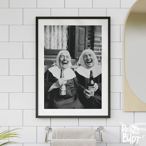 May include: Two women dressed as nuns are laughing while holding bottles of beer. The photo is in black and white.