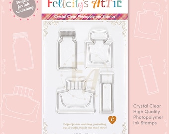 May include: Clear photopolymer ink stamps from Felicity's Attic. The set includes four different ink bottle designs. The packaging features the text "Crystal Clear Photopolymer Stamps" and "Perfect for ink swatching, journaling, arts & crafts projects and much more!"