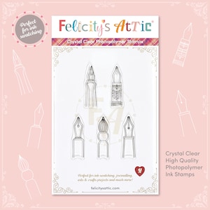 May include: Clear photopolymer ink stamps with six pen nib designs. The stamps are labelled "Felicity's Attic" and described as "Crystal Clear High Quality Photopolymer Ink Stamps". The packaging is light pink with decorative pen nib outlines.