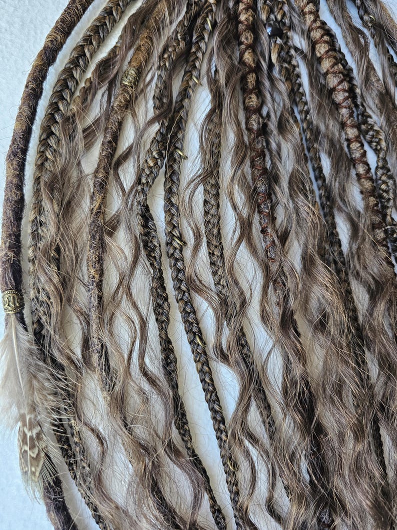 Handcrafted synthetic dreads extensions with intricate braided dreads and curls. Decorated with feathers, copper charms, beads, threads, this ponytail is easy to attach and remove, offering a hassle-free alternative to permanent dreads installations.