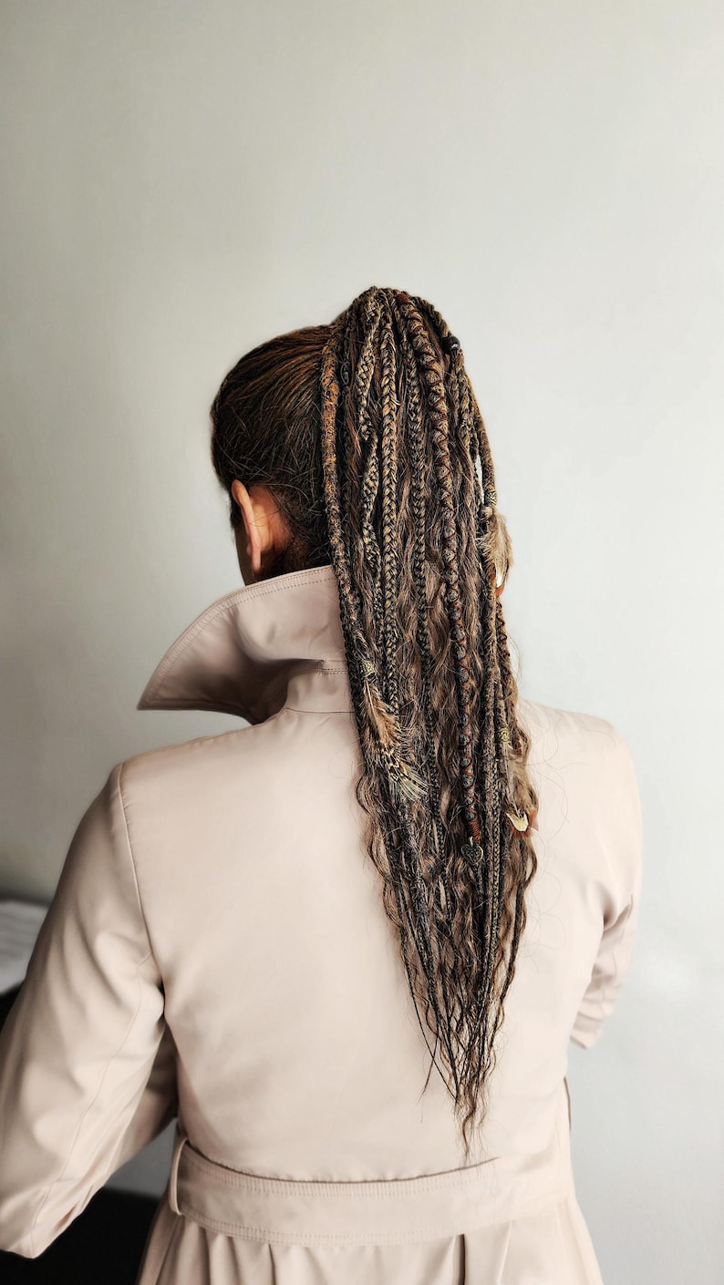 Braids on hairband with dreads on elastic band, combining curls, braids, and dreadlocks for a stylish look. This handmade temporary ponytail is adorned with feathers, copper charms, beads, threads, perfect for creating bohemian or festival hairstyles