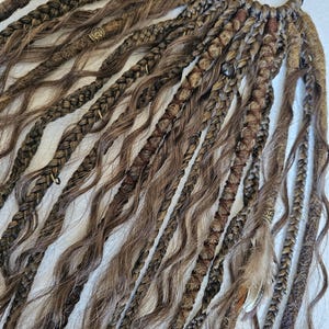 Handmade kinky curly ponytail with brown braids tail, featuring a mix of curls, braids, and dreadlocks. Decorated with feathers, copper charms, beads, and threads, this piece is perfect for bohemian styles or adding a unique touch to your look.