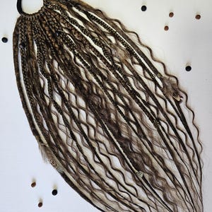 Synthetic dreads extensions with braids in dreads, combining braided dreads and curls for a unique look. This handmade piece is perfect for bohemian styles, featuring feathers, copper charms, beads, and threads for added flair.