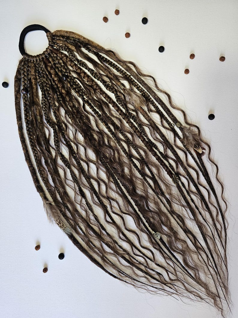 Synthetic dreads extensions with braids in dreads, combining braided dreads and curls for a unique look. This handmade piece is perfect for bohemian styles, featuring feathers, copper charms, beads, and threads for added flair.