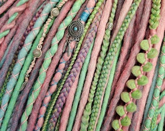 May include: A close-up of a set of synthetic dreadlocks in shades of pink, green, and blue. The dreadlocks are decorated with beads and charms.