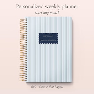 May include: A weekly planner with a light blue and white pinstripe cover and gold spiral binding. A dark blue scalloped label on the front reads 2027 PLANNER and Jessica Fountain. The text Personalized weekly planner start any month 6x9 Choose Your Layout is visible.