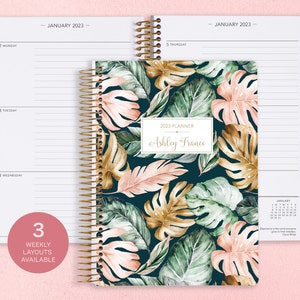 6x9 inches Posy Paper Co. 2023/2024 weekly planner with the green blush gold tropical cover design showcasing horizontal layout in the background