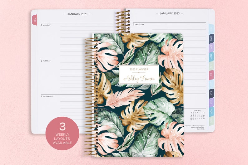 6x9 inches Posy Paper Co. 2023/2024 weekly planner with the green blush gold tropical cover design showcasing horizontal layout in the background