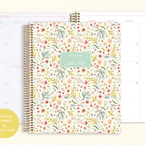 8.5x11" Posy Paper Co. 2023/2024 monthly planner with the meadow floral cover design showcasing 2 page monthly spread layout in the background.