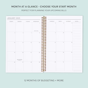 May include: A monthly planner with a white cover and gold spiral binding. The planner has a calendar for January 2025 with spaces for notes. The text "MONTH AT A GLANCE - CHOOSE YOUR START MONTH" is at the top of the page. The text "PERFECT FOR PLANNING YOUR UPCOMING BILLS" is below the first line of text. The text "JANUARY 2025" is at the top of the calendar. The text "12 MONTHS OF BUDGETING + MORE" is at the bottom of the page.