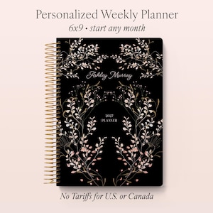 May include: A black weekly planner with gold spiral binding, featuring a delicate botanical illustration in white and soft pink. The cover displays the text Personalized Weekly Planner, 6x9, start any month, Ashley Murray, 2027 PLANNER, and No Tariffs for U.S. or Canada.