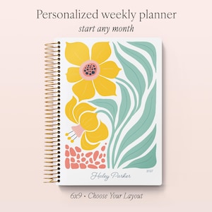 May include: A 6x9 inch personalized weekly planner with a gold spiral binding. The cover features a white background with yellow flowers, green leaves, and pink abstract shapes. The text reads Personalized weekly planner, start any month, Haley Parker, 2027, and 6x9 Choose Your Layout.
