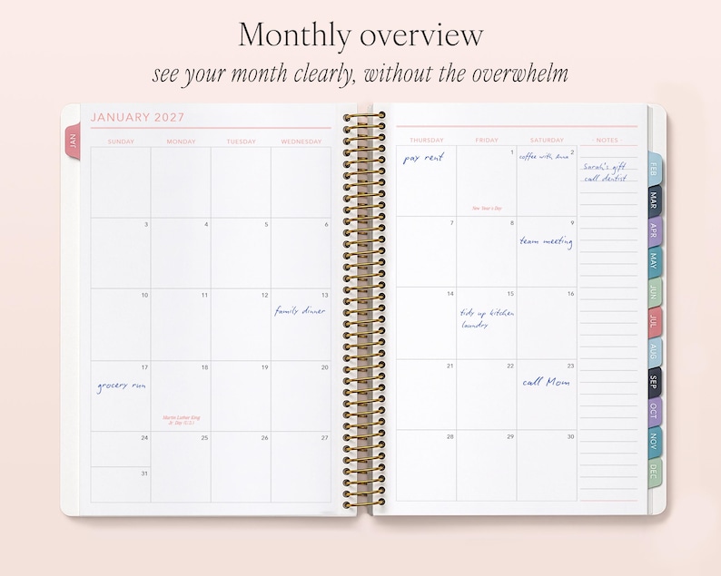 a spiral-bound notebook with a Monthly overview page, showing a calendar for January 2023 and a Monthly overview page with a list of tasks and events.