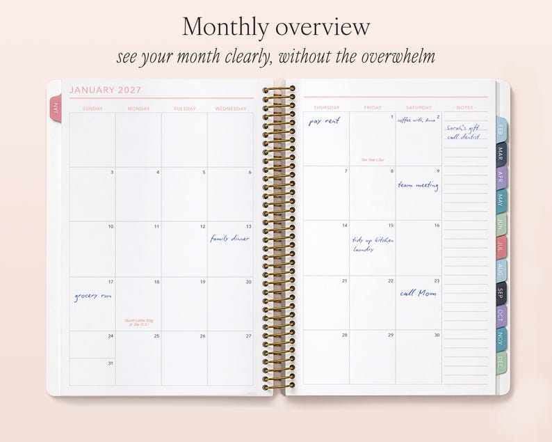 a spiral-bound notebook with a Monthly overview page, showing a calendar for January 2023 and a Monthly overview page with a list of tasks and events.
