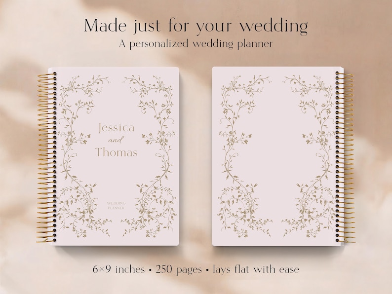 May include: Two wedding planners with a light pink cover and gold spiral binding. The cover features a floral design and the names "Jessica and Thomas". The planner is 6x9 inches and has 250 pages.