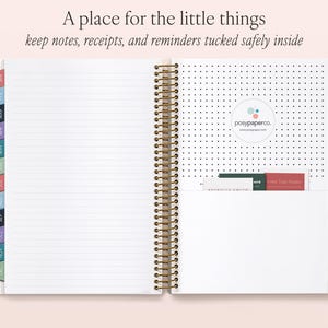 an open spiral-bound notebook with a blank page, a pocket on the right side, and a section of the notebook with a logo and text visible.