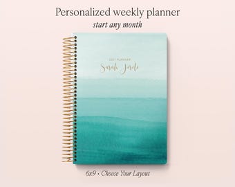 May include: A personalized weekly planner with a spiral gold-tone metal binding. The cover features an ombre watercolor design transitioning from light mint to deep teal. The text reads 2027 PLANNER and Sarah Jerde in gold script.