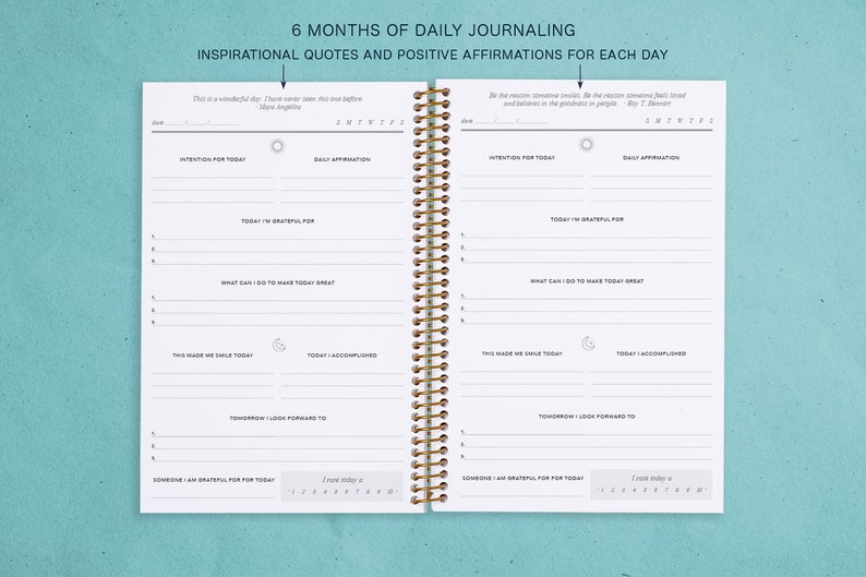 May include: A white journal with a gold spiral binding. The journal is divided into sections for daily journaling, including "Today I'm Grateful For", "What Can I Do To Make Today Great", "This Made Me Smile Today", "Today I Accomplished", "Tomorrow I Look Forward To", and "Someone I Am Grateful For Today". The journal also includes inspirational quotes and positive affirmations for each day.