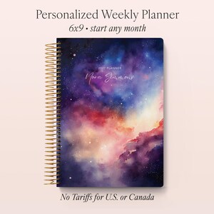 May include: A personalized weekly planner with a galaxy-themed cover. The spiral-bound planner is 6x9 inches and features a vibrant watercolor design in shades of purple, blue, red, and gold. The text "2027 Planner" and a name are visible on the cover.
