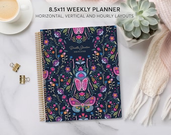 May include: An 8.5 x 11 inch weekly planner with a navy blue cover featuring a floral and insect design. The planner has a gold spiral binding and includes horizontal, vertical, and hourly layouts. The text "Brielle Stanton 2024 Planner" is visible.