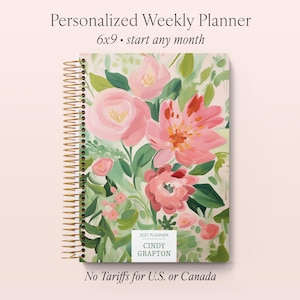 May include: A personalized weekly planner with a floral design. The cover features pink flowers and green leaves. The planner is 6x9 inches and has a gold spiral binding. The text on the cover reads "Personalized Weekly Planner" and "start any month."
