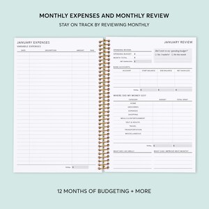 May include: A monthly budget planner with a white cover and gold spiral binding. The planner includes sections for tracking monthly expenses, reviewing spending, and setting financial goals. The text on the cover reads "Monthly Expenses and Monthly Review" and "Stay on Track by Reviewing Monthly".