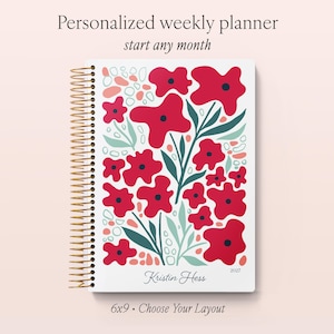 May include: A spiral-bound weekly planner with a white cover featuring a red floral pattern, dark green leaves, and peach-coloured accents. The text reads Personalized weekly planner, start any month, Kristin Hess, and 2027. It measures 15x23 cm.