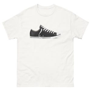 May include: White t-shirt with a black and white Converse shoe graphic.