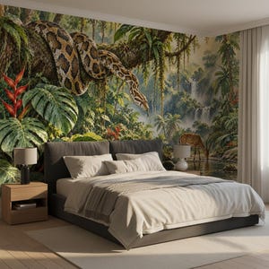 May include: A bedroom featuring a large wall mural of a jungle scene with a large patterned snake coiled on a tree branch, lush green foliage, red tropical flowers, a waterfall, and a deer drinking from a stream behind a grey upholstered bed.