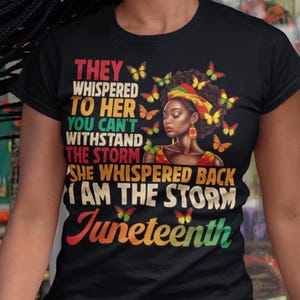 Może przedstawiać: Czarny t-shirt z grafiką przedstawiającą portret kobiety, motyle i napis "THEY WHISPERED TO HER YOU CAN'T WITHSTAND THE STORM SHE WHISPERED BACK I AM THE STORM Juneteenth."