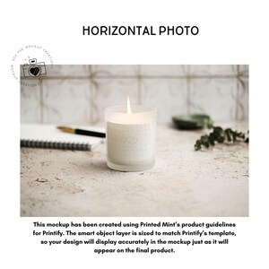 May include: A lit candle in a frosted glass jar with a dotted label. The candle sits on a textured surface with a notebook, pen, and greenery in the background. The text "HORIZONTAL PHOTO" is above the candle.