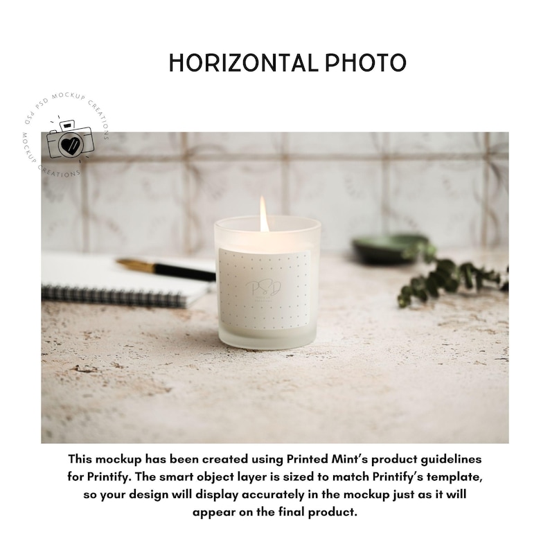May include: A lit candle in a frosted glass jar with a dotted label. The candle sits on a textured surface with a notebook, pen, and greenery in the background. The text "HORIZONTAL PHOTO" is above the candle.