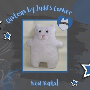May include: A white plush cat toy with black eyes and a pink nose and mouth. The image includes the text "Customs by Judd's Corner" and "Kool Kats!" with blue stars on a gray background.