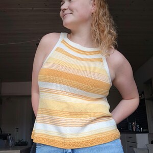May include: A yellow and white striped sleeveless knit top with a scoop neck.
