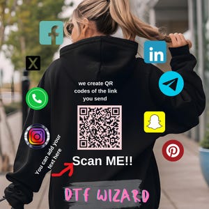May include: Black hoodie with a QR code and the text "we create QR codes of the link you send" and "Scan ME!!" and "DTF WIZARD". The hoodie has various social media icons printed on it, including Facebook, Instagram, Twitter, LinkedIn, Pinterest, Snapchat, and Telegram.