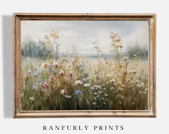 Könnte beinhalten: Gerahmtes Landschaftsgemälde mit einem Feld aus Wildblumen in Rosa, Blau, Gelb und Weiß. Das Kunstwerk ist vor einem weichen, bewölkten Himmel platziert und in einem hellbraunen Holzrahmen eingefasst. Der Text "RANFURLY PRINTS" befindet sich unten.