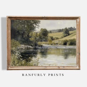 May include: A framed painting depicting a landscape with a river meandering through a verdant valley. The river reflects the sky and trees. The painting is in a wooden frame.