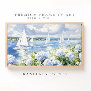 May include: A framed painting of sailboats on a blue sea under a cloudy sky. White sailboats with billowing sails are depicted on the water. The painting includes blue hydrangeas in the foreground. Text at the top reads "PREMIUM FRAME TV ART 3840 X 2160" and at the bottom "RANFURLY PRINTS."