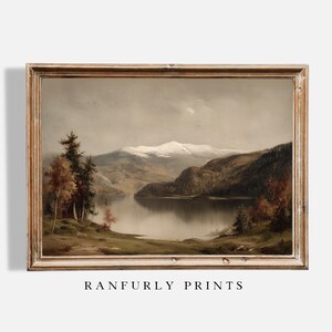 May include: A framed landscape painting depicts a serene lake scene with snow-capped mountains in the background. The artwork features a muted color palette with trees and foliage in the foreground. The text "RANFURLY PRINTS" is at the bottom.
