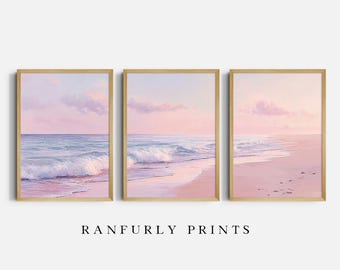 May include: Three framed art prints depicting a serene beach scene. The artwork features a pastel color palette of pink, blue, and white, with gentle waves and a soft sky. The text "RANFURLY PRINTS" is printed below the frames.