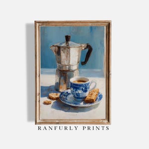 May include: A vintage-style painting of a coffee setup. It features a silver espresso maker, a blue and white teacup and saucer, and biscuits. The artwork has a blue backdrop and a wooden frame. The text "RANFURLY PRINTS" is visible at the bottom.