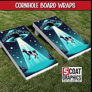 May include: Two cornhole boards with a space-themed design. Each board features a black and white cow being beamed up by a UFO against a starry night sky. The boards have a white frame and the text "Cornhole Board Wraps".