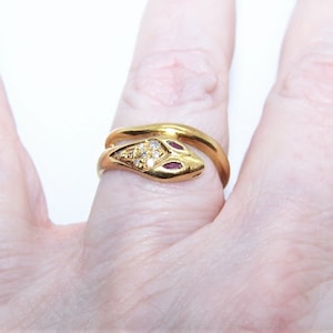 May include: A white ceramic mug with a black handle and the text "But first, coffee" in a handwritten style. The mug is on a white surface. The mug is 4 inches tall.